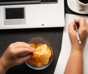 eating junk food working on laptop from home